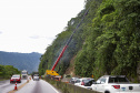 Morretes, 10 de fevereiro de 2023 - Guindastes realizam a recuperação do morro na BR 277, sentindo litoral paranaense, nas proximidades do viaduto do padre.