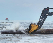 Tubulação de aço para dragagem da praia de Matinhos é transportada para o mar