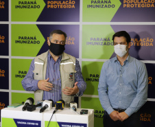 O  Secretário de Estado da Saúde, Beto Preto e o vice-prefeito Eduardo Pimentel recebem o primeiro lote de  32.760 doses de vacinas contra a Covid-19 da  Pfizer   no Centro de Medicamentos do Paraná (Cemepar), em Curitiba, na noite desta segunda-feira (3).  Foto: Geraldo Bubniak/AEN